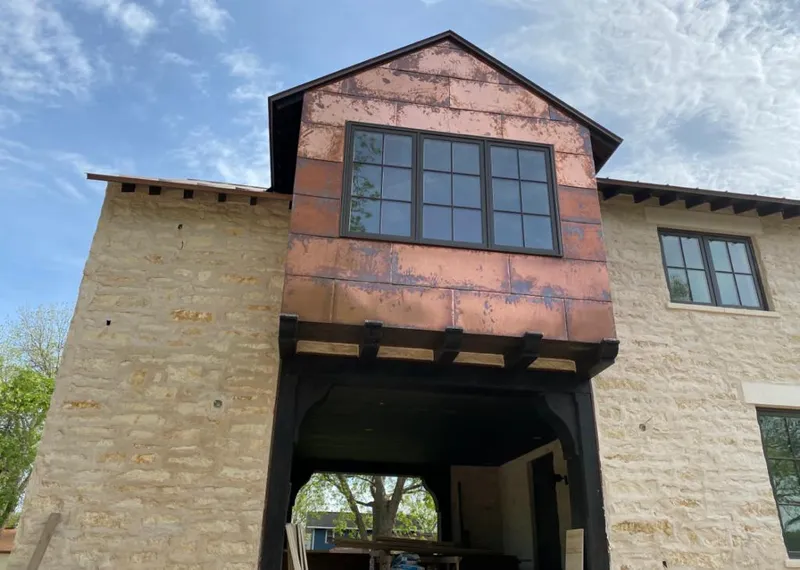 Copper metal panel facade on a stone building for Skylight Installation in North Druid Hills
