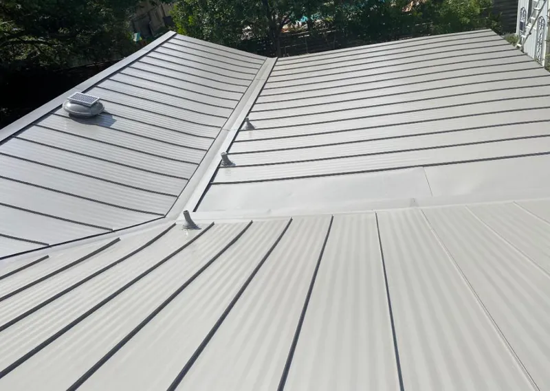 Solar attic fan installed on a metal roof for Roof Ventilation in North Druid Hills