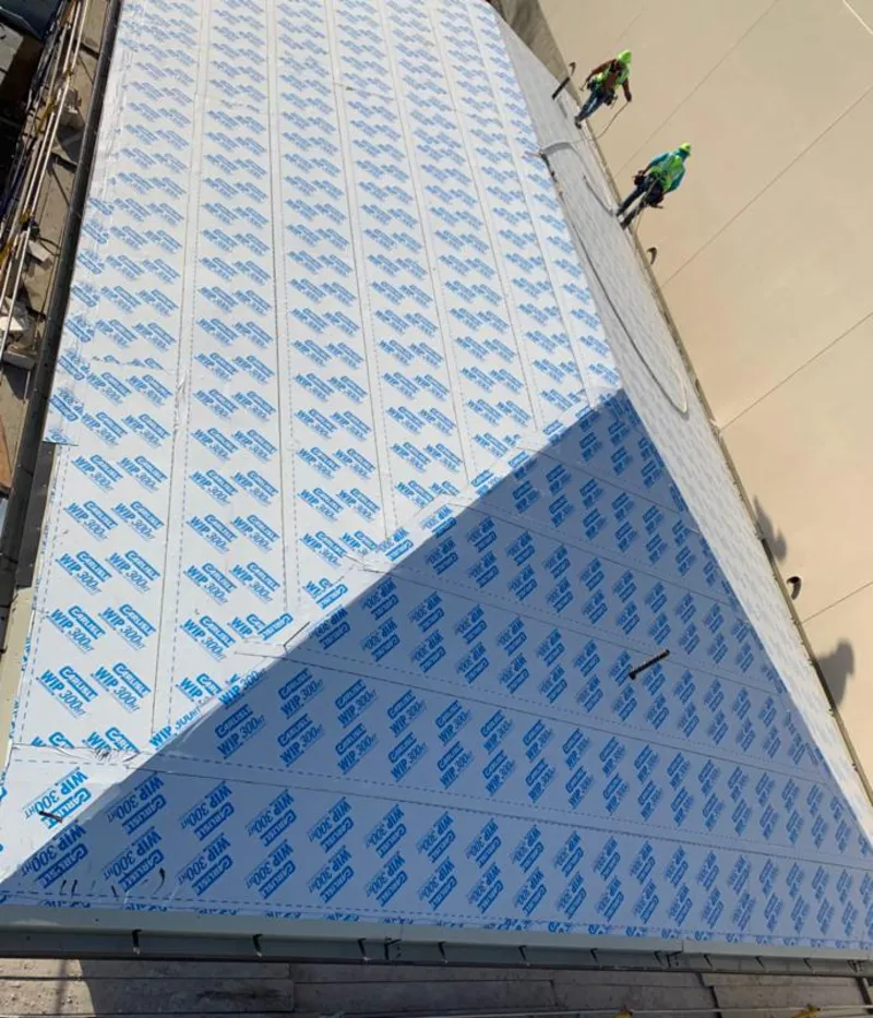 Professional roofers installing underlayment on a metal roof in North Druid Hills